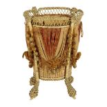 A Victorian gilt wicker waste paper basket, with silk and velvet swags, 47.8cm high, 36.2cm deep.