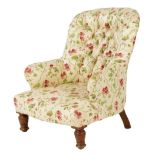 A late Victorian walnut lady's armchair, the button upholstered back on turned front legs.