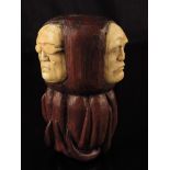 λ A stained pine and ivory cane handle, inset with three carved ivory grotesque heads, 19th century,