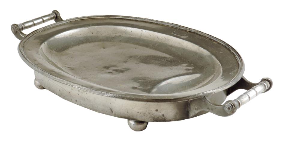 A George III pewter warming meat plate, with a pair of handles on ball feet, the underside