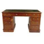 A Victorian mahogany twin pedestal desk, the moulded edge top inset with a green leather writing