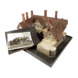 A painted pine architectural scale model of a timber framed Tudor house, in two halves, the top