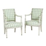 A pair of Louis XVI painted fauteuil, each upholstered with later green check fabric on part