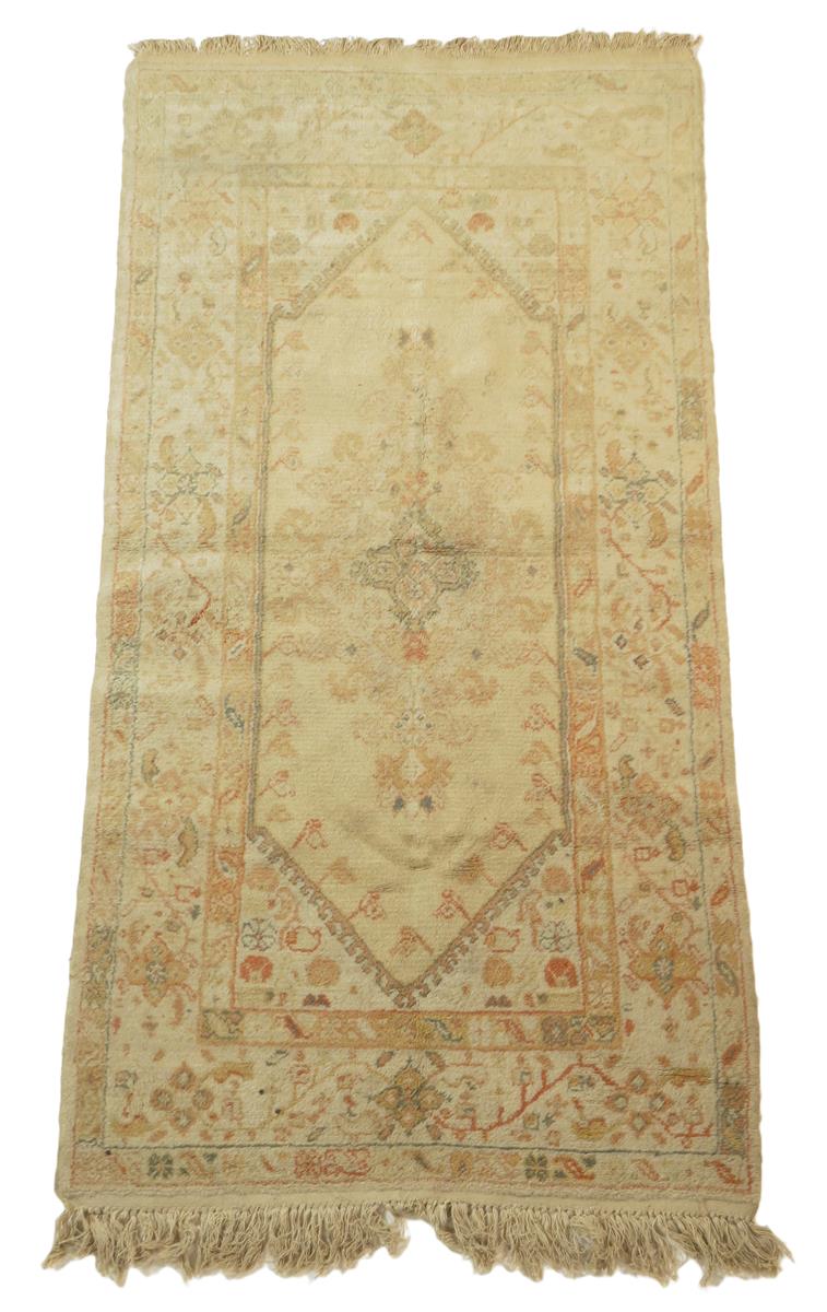Two Turkish rugs, one with an all over floral field, the other with an elongated central