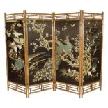 A late Victorian bamboo four-fold screen, with silkwork embroidered panels, decorated with various