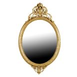 A Victorian giltwood wall mirror, the bevelled oval plate to a moulded frame and with a leaf