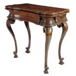 An early 18th century Italian walnut serpentine tea table, the hinged fold-over top banded in ash