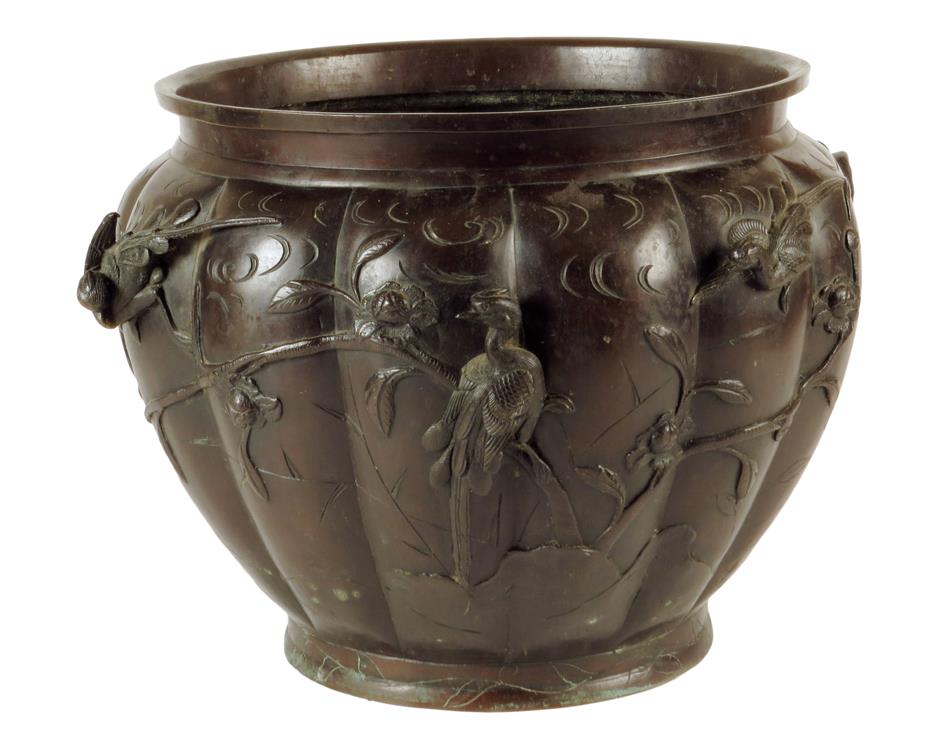 A Japanese bronze jardinière, the lobed body decorated with birds amongst trees, the base with a