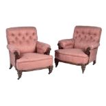 A pair of late Victorian walnut armchairs in the manner of Gillow & Co., with scroll backs and arms,