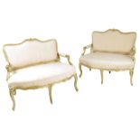 A pair of Louis XV giltwood canapé, each with a moulded frame with a flower and leaf surmount, to