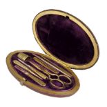 A Victorian red leather and brass mounted oval étui, the plush lined interior fitted with gilt brass