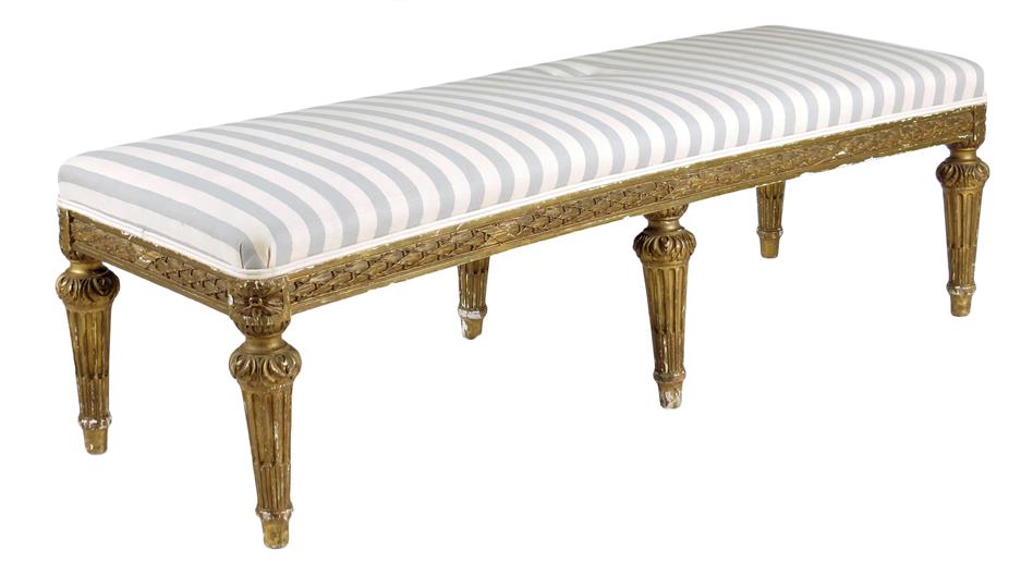 A giltwood long stool in Louis XVI style, the padded seat upholstered with later striped fabric
