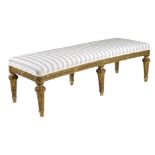A giltwood long stool in Louis XVI style, the padded seat upholstered with later striped fabric