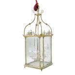 A late 19th century gilt brass hall lantern, with four cut and bevelled glass panels with beaded