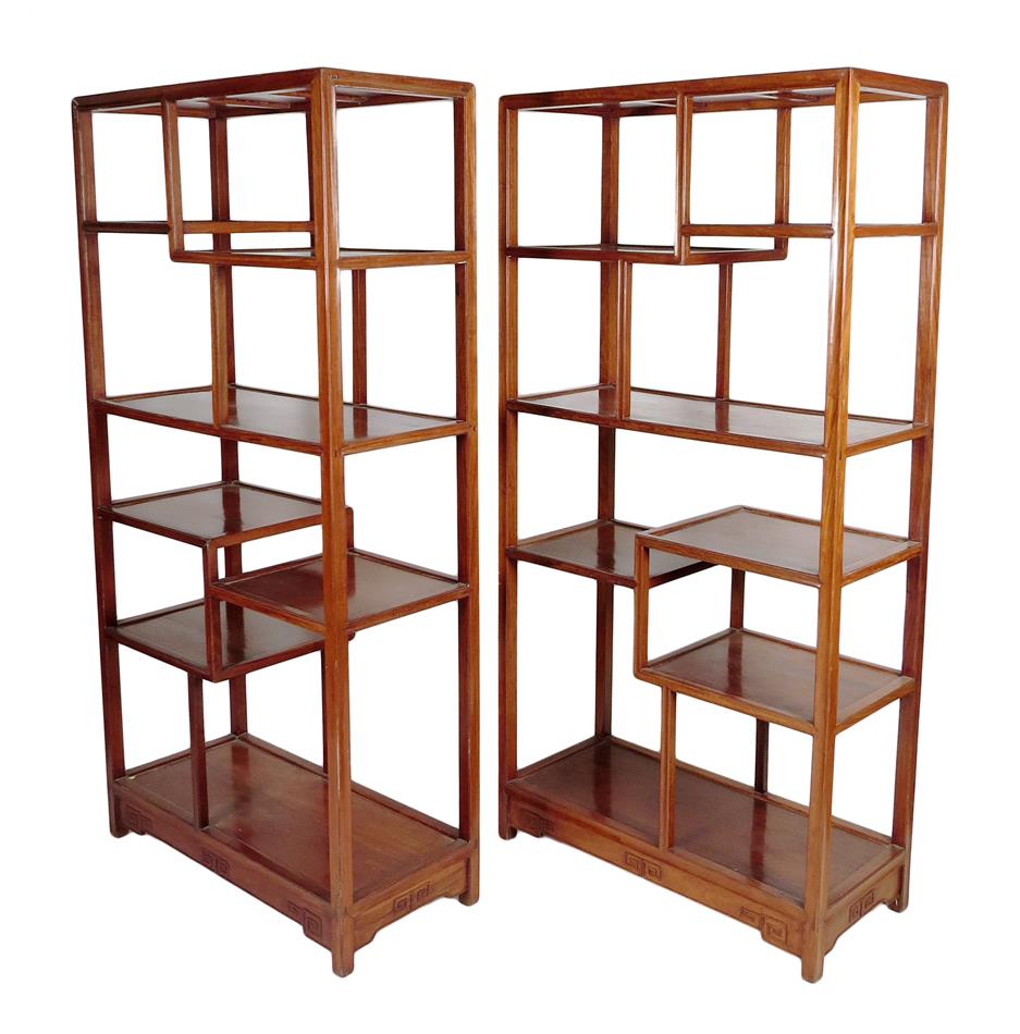 A pair of Chinese hardwood Ming style open display shelves, the bases carved with Greek key