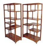 A pair of Chinese hardwood Ming style open display shelves, the bases carved with Greek key
