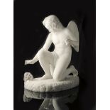 A 19th century carved white marble model of Cupid, kneeling with his right hand outstretched towards