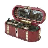 λ A mid 19th century red leather and ivory mounted étui, the hinged lid with an agate cabochon,