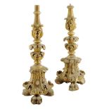 Two similar Italian carved giltwood altar candlestick bases, each decorated with scrolling leaves,