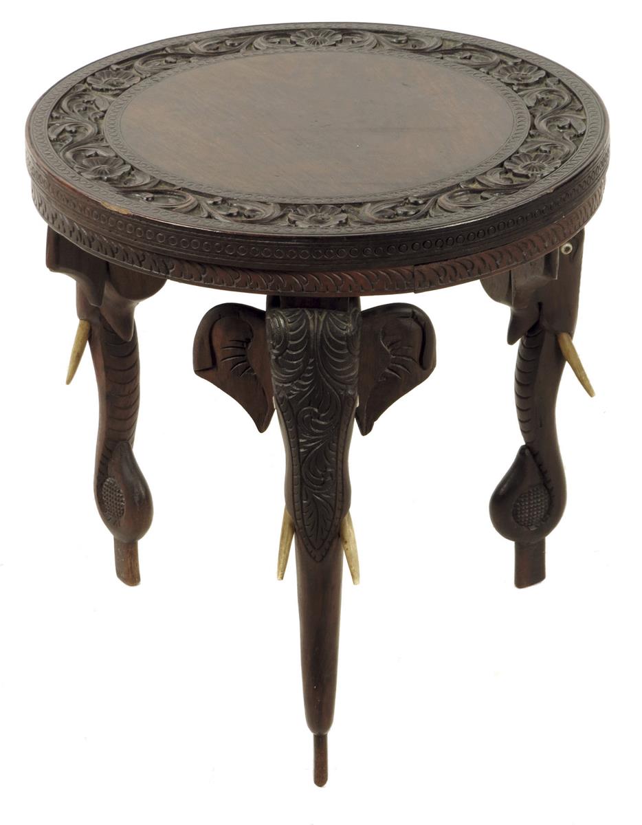 An Indian hardwood occasional table, on three elephant's head and trunk legs, late 19th / early 20th