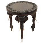 An Indian hardwood occasional table, on three elephant's head and trunk legs, late 19th / early 20th