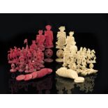 λ A late 19th century Chinese Canton carved ivory figural part chess set, with puzzle ball bases,