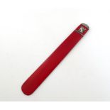 By Faberge, a silver-mounted red lacquer paper knife, the Faberge mark slightly mis-struck, also