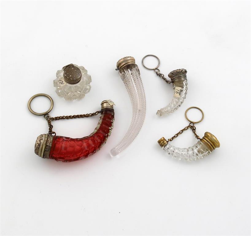 A small collection of four silver-mounted horn shape scent bottles, comprising: one with a red glass