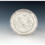 A late 17th century silver West Country paten or small footed dish in the Chinoiserie manner, by