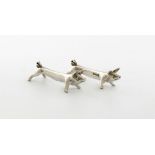A pair of novelty silver pig knife rests, by William Hutton and Sons, Sheffield 1911, modelled in