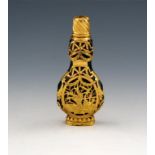 A late 18th century gold-mounted green glass scent bottle, unmarked, probably English, compressed