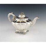 λ A Victorian silver teapot, by William Smily, London 1844, circular tapering fluted form, scroll