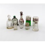 A collection of nine silver-mounted glass scent bottles / smelling salts bottles, various dates