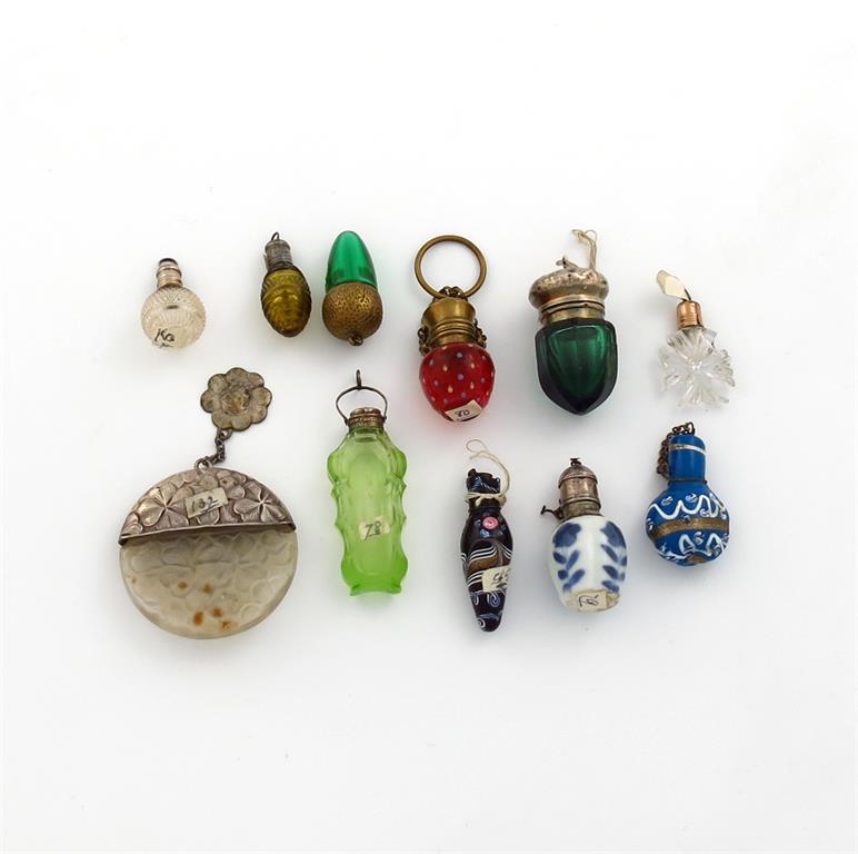 A collection of miniature scent bottles, various materials, comprising: a silver-mounted blue and