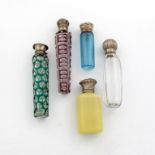 A collection of five Victorian silver-mounted glass scent bottles, comprising: one of faceted