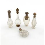 A small collection of five 19th century Dutch silver-mounted scent bottles, various designs, the