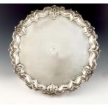 A large silver salver, by Walker and Hall, Sheffield 1915, circular form, foliate scroll border, the