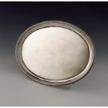 A George III silver salver, by William Bennett, London 1808, oval form, moulded border, on four