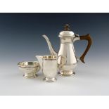 By A .E. Jones, a three-piece Arts and Crafts silver bachelor's coffee set, Birmingham 1918,