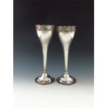 A pair of silver vases, by Mappin and Webb, London 1925, tapering circular form, pierced foliate