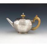 λ A George I silver teapot, unmarked, circa 1720, octagonal form, flush hinged cover with an ivory