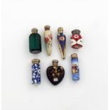 A small collection of seven silver-mounted ceramic and glass scent bottles, comprising: one of heart