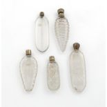 A small collection of five 19th century silver-mounted clear glass bottles, unmarked, various shapes