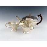 A three-piece silver Arts and Crafts tea set, by William H Haseler, Birmingham 1910, tapering