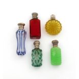 A collection of five Victorian silver-mounted coloured glass scent bottles, comprising: one of