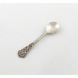 By Alywn Carr, an Arts and Crafts silver spoon, London 1923, tapering handle, the terminal with