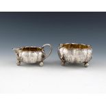 A Victorian silver naturalistic cream jug and sugar bowl, London 1885, retailed by Thornhill and Co,