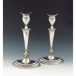 A pair of Edwardian silver candlesticks,  by Thomas Bradbury, London 1904, tapering oval form,