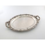 A George III silver two-handled meat platter, by Paul Storr, London 1817, oval form, foliate and