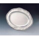 A George III silver meat platter, by Sebastian and James Crespell, London 1763, shaped oval form,